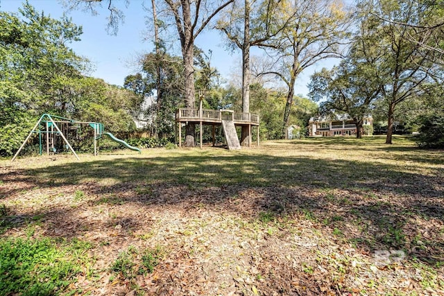 view of yard featuring stairs, a playground, and a wooden deck