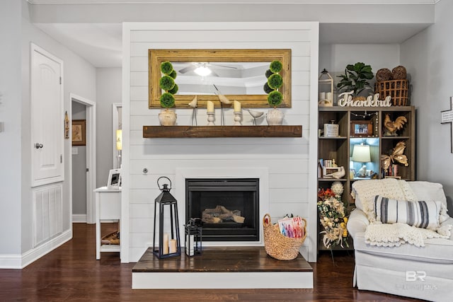 living room featuring ceiling fan and dark hardwood / wood-style flooring