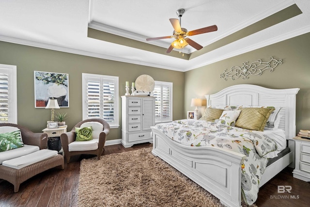 bedroom featuring dark hardwood / wood-style flooring, ceiling fan, and crown molding