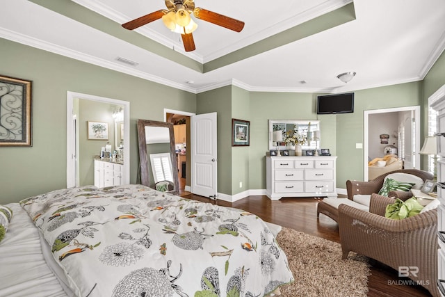 bedroom with connected bathroom, dark wood-type flooring, ceiling fan, and ornamental molding