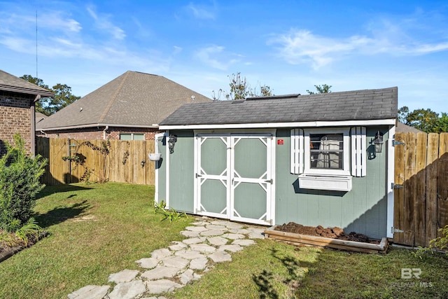 view of outbuilding featuring a lawn