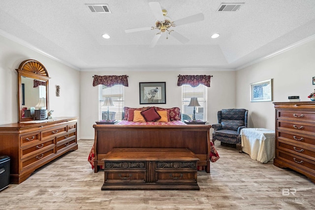 bedroom featuring light wood-type flooring, visible vents, and multiple windows