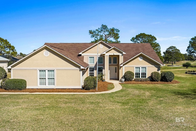 traditional home featuring a front yard and stucco siding