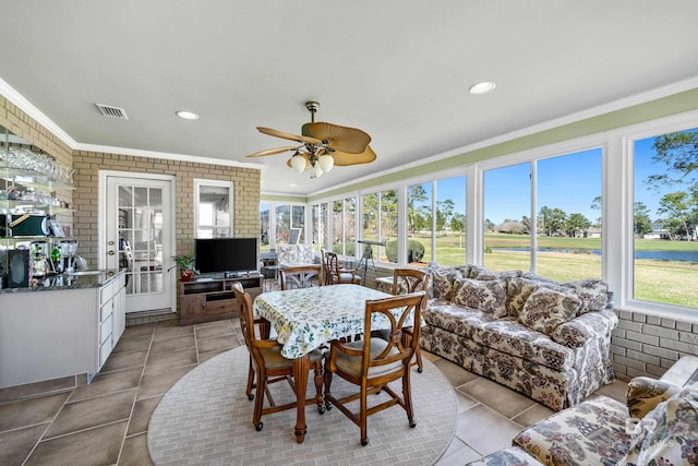 sunroom featuring visible vents and a ceiling fan