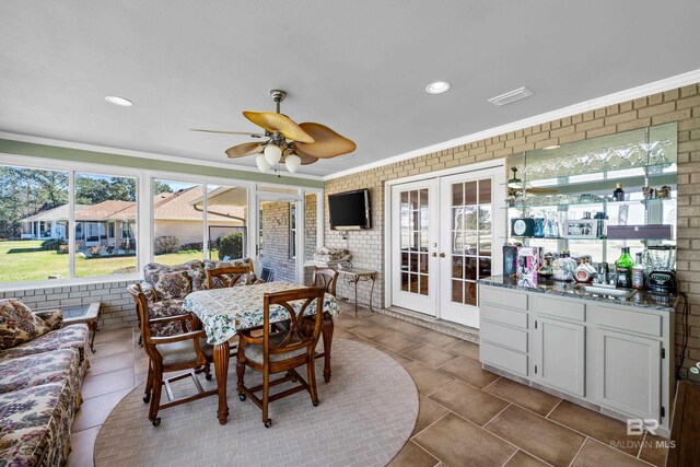 sunroom featuring visible vents, french doors, a sink, and a ceiling fan