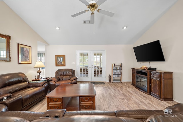 living room featuring french doors, visible vents, light wood-style floors, vaulted ceiling, and ceiling fan