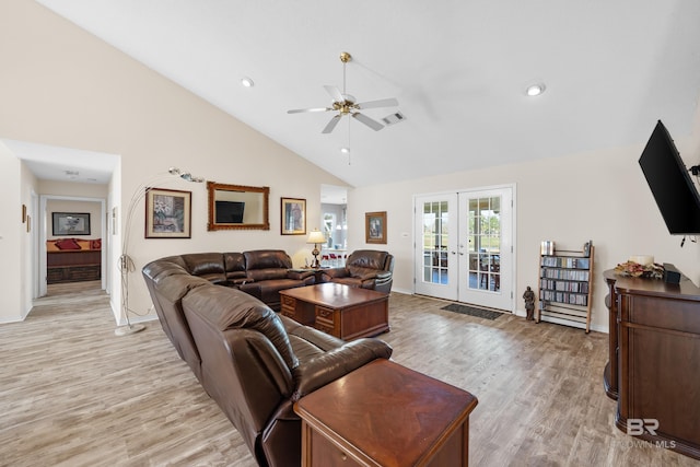 living area featuring high vaulted ceiling, visible vents, a ceiling fan, french doors, and light wood finished floors