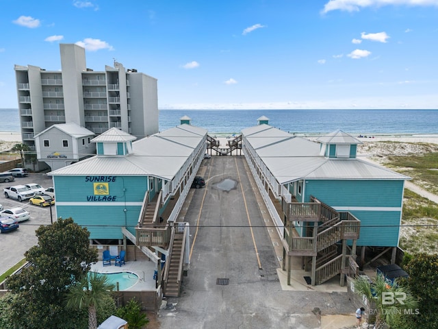 drone / aerial view featuring a view of the beach and a water view