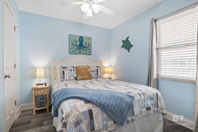 bedroom with a ceiling fan, baseboards, and wood finished floors