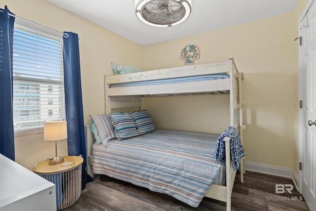 bedroom featuring baseboards and wood finished floors