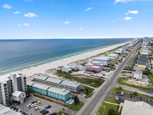 bird's eye view with a water view and a beach view