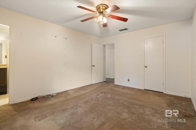 2405 Pavan Dr, Mobile, AL 36693 - unfurnished bedroom with visible vents, baseboards, carpet, a ceiling fan, and ensuite bath