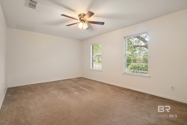 2405 Pavan Dr, Mobile, AL 36693 - carpeted empty room with a textured ceiling, visible vents, a ceiling fan, and baseboards