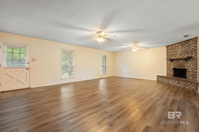 2405 Pavan Dr, Mobile, AL 36693 - unfurnished living room featuring wood finished floors, ceiling fan, and plenty of natural light