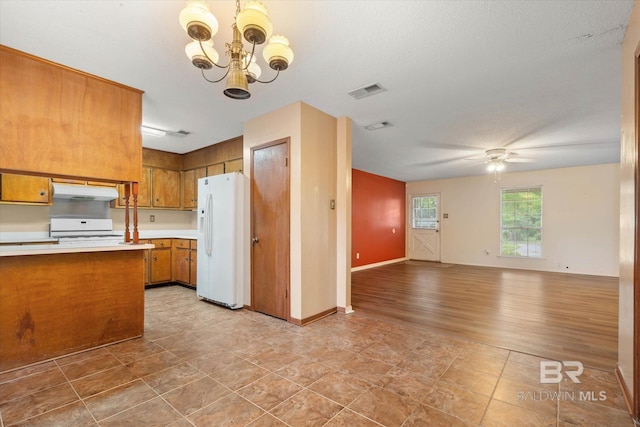 2405 Pavan Dr, Mobile, AL 36693 - kitchen with white appliances, brown cabinetry, light countertops, open floor plan, and ceiling fan with notable chandelier
