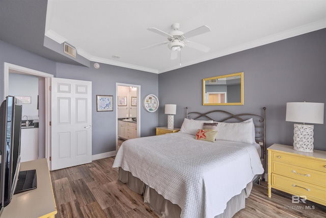 bedroom featuring crown molding, dark hardwood / wood-style floors, connected bathroom, and ceiling fan