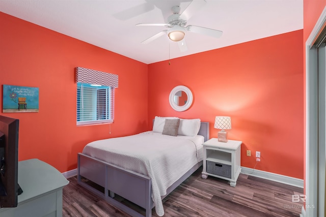 bedroom with ceiling fan and dark hardwood / wood-style floors