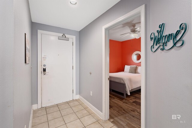 entryway with ceiling fan and light hardwood / wood-style flooring