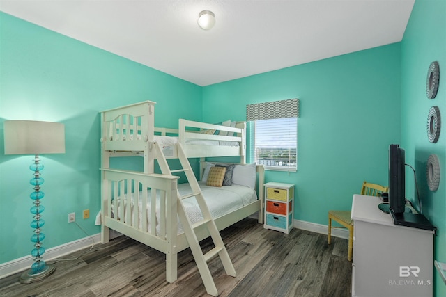 bedroom with dark wood-type flooring