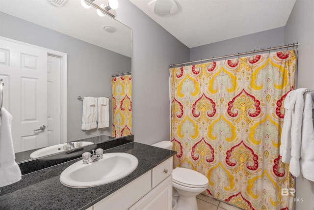 bathroom featuring vanity, walk in shower, toilet, and tile patterned flooring