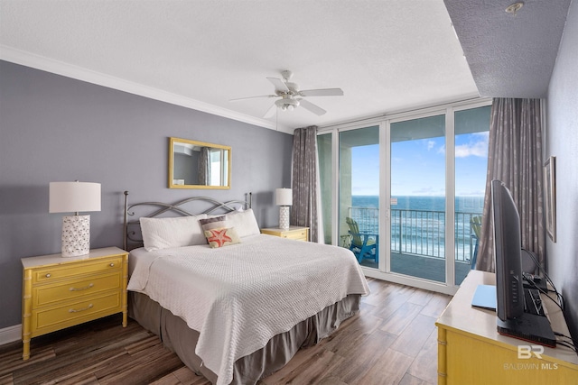 bedroom featuring access to outside, ceiling fan, floor to ceiling windows, and dark hardwood / wood-style flooring