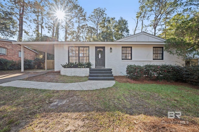 single story home featuring a front lawn and a carport