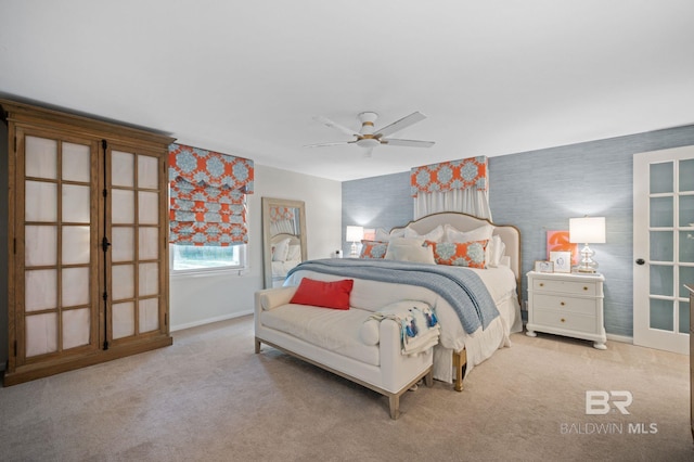 carpeted bedroom with ceiling fan and french doors