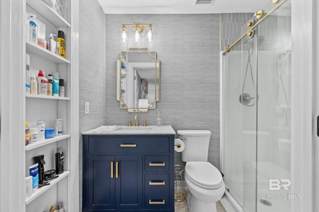 bathroom featuring built in features, an enclosed shower, toilet, vanity, and tile walls