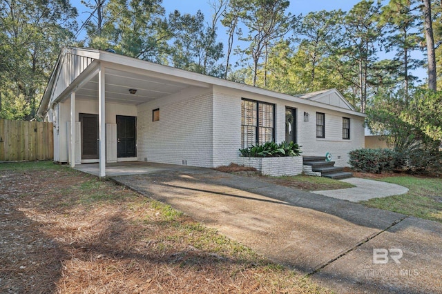 ranch-style house featuring a carport