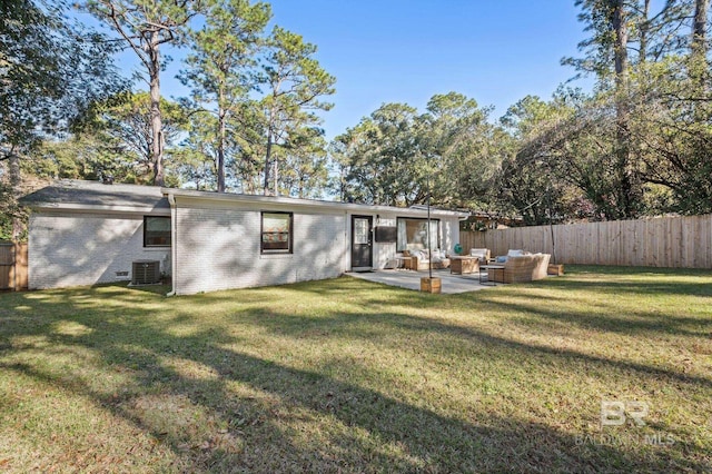 back of property with outdoor lounge area, a yard, a patio, and cooling unit