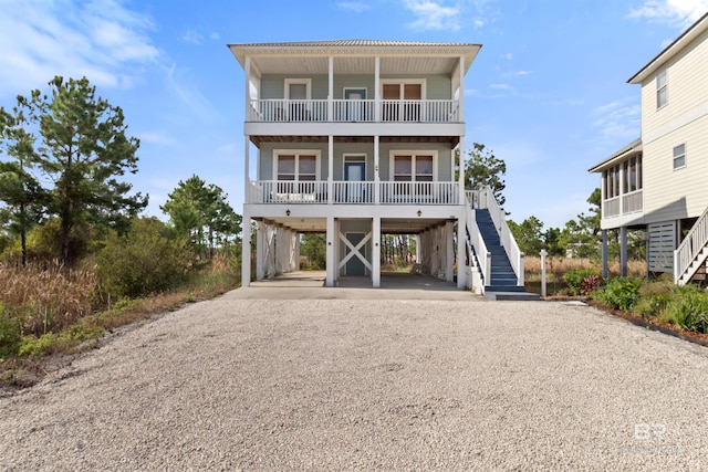 729 Morgantown Blvd, Gulf Shores, AL 36542 - beach home with stairway, a carport, driveway, and a balcony