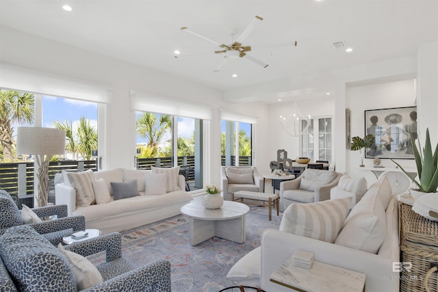living room featuring recessed lighting, visible vents, and ceiling fan with notable chandelier