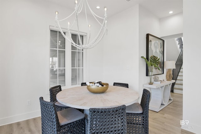 dining room featuring an inviting chandelier, recessed lighting, baseboards, light wood-type flooring, and stairway