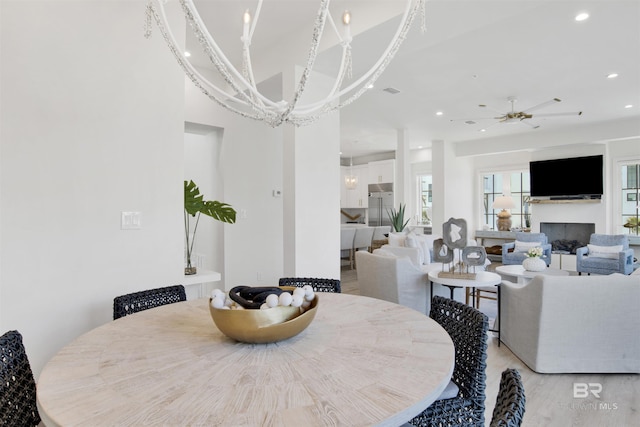 dining room with recessed lighting, light wood-style flooring, and a wealth of natural light