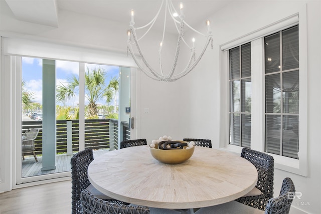 dining area featuring an inviting chandelier and wood finished floors