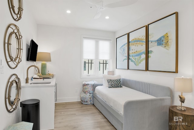 bedroom with recessed lighting, baseboards, a sink, and light wood-style flooring