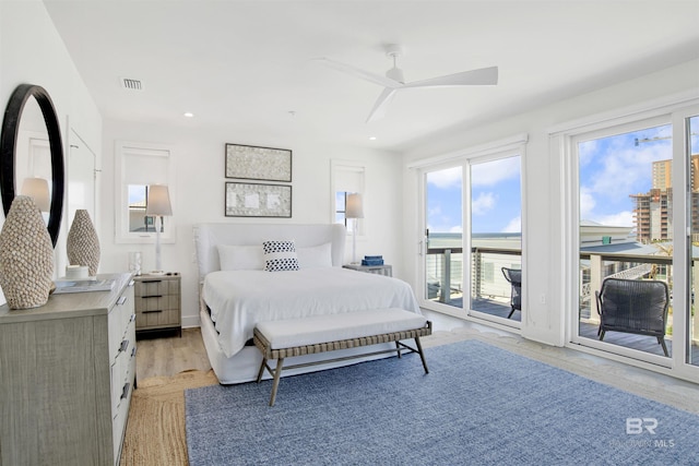 bedroom featuring access to outside, light wood-style floors, visible vents, and multiple windows