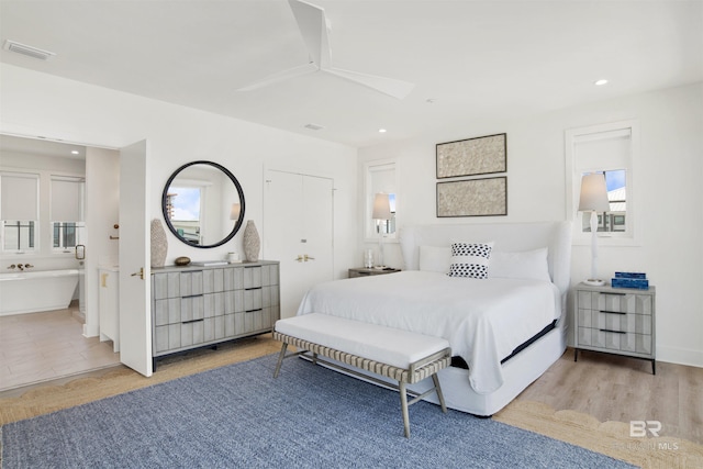 bedroom with recessed lighting, visible vents, and ensuite bathroom