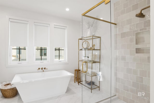 bathroom featuring recessed lighting, marble finish floor, a freestanding bath, and a stall shower