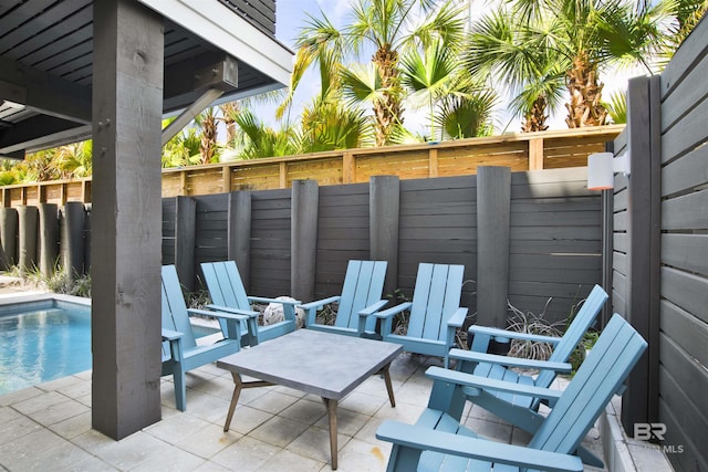 view of patio / terrace featuring a fenced in pool and fence