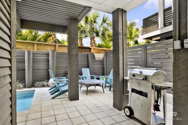 view of patio featuring fence and grilling area