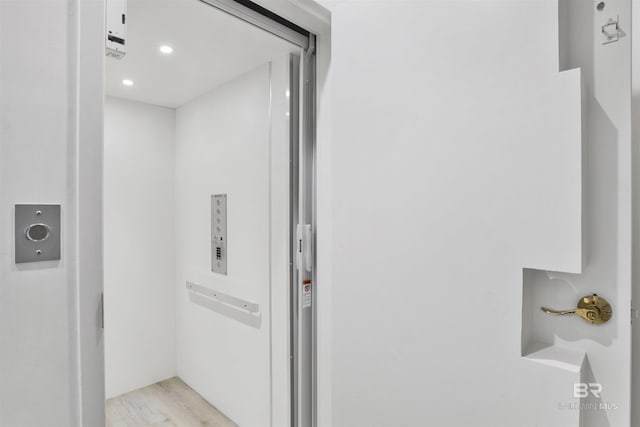 room details with recessed lighting, elevator, and wood finished floors