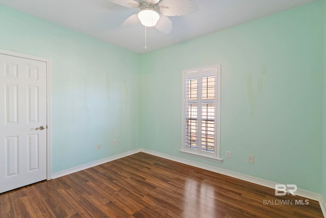 empty room featuring ceiling fan and dark hardwood / wood-style flooring