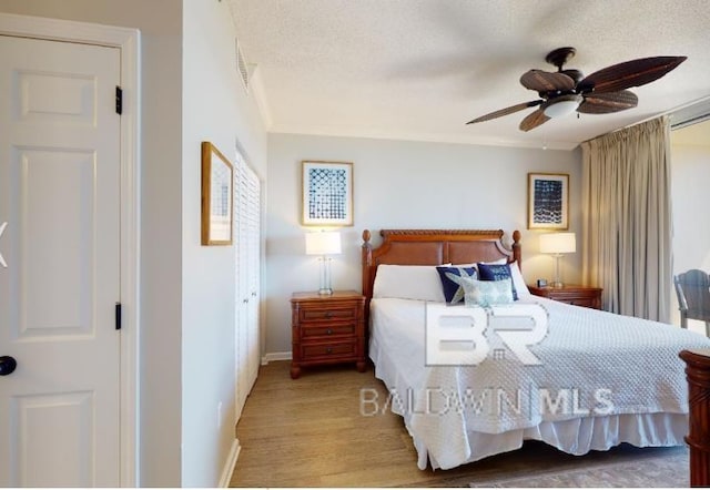 527C Beach Club Trl Unit C-0104, Gulf Shores, AL 36542 - bedroom with wood finished floors and a ceiling fan