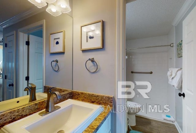 527C Beach Club Trl Unit C-0104, Gulf Shores, AL 36542 - full bathroom with vanity, a textured ceiling, ornamental molding, wood finished floors, and a shower