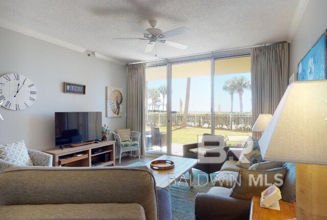 527C Beach Club Trl Unit C-0104, Gulf Shores, AL 36542 - living area with floor to ceiling windows, a textured ceiling, a ceiling fan, ornamental molding, and wood finished floors