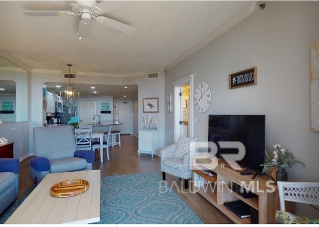 527C Beach Club Trl Unit C-0104, Gulf Shores, AL 36542 - living room with ornamental molding, dark wood-style flooring, and a ceiling fan