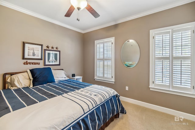 bedroom with ceiling fan, baseboards, carpet floors, and ornamental molding