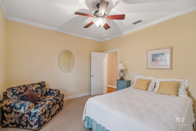 carpeted bedroom featuring visible vents, a ceiling fan, baseboards, and ornamental molding