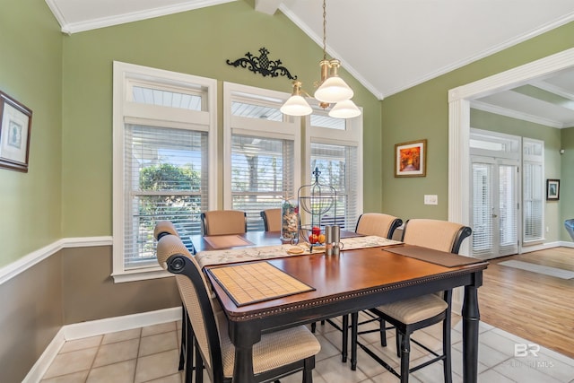 dining room featuring baseboards, ornamental molding, and vaulted ceiling